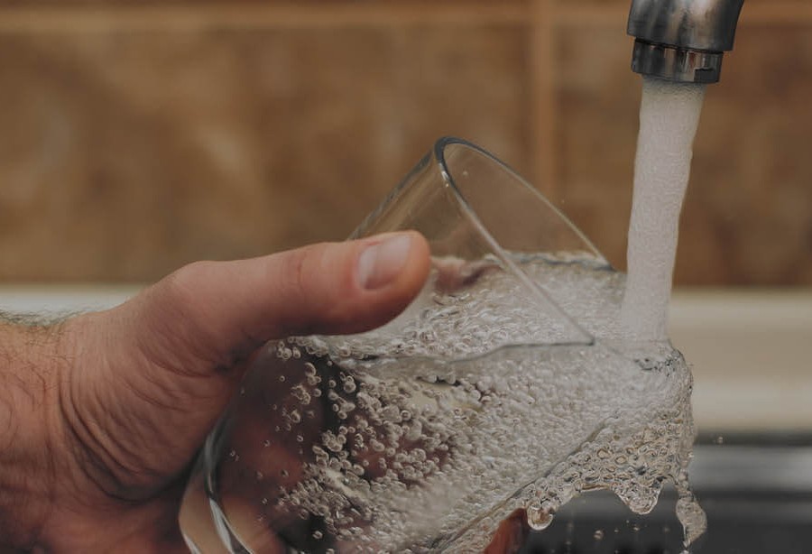 Testing the tap water during a legionella risk assessment (LRA) in Edinburgh.