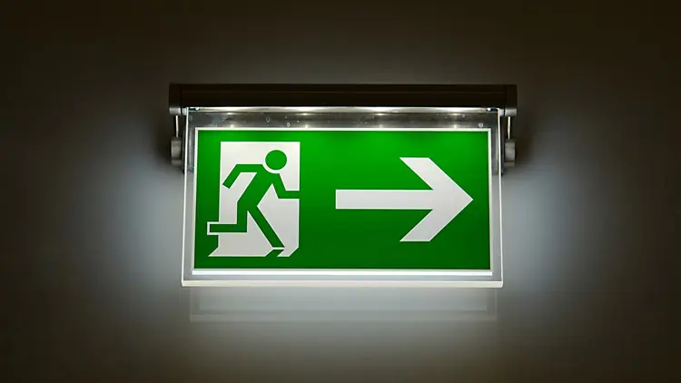 Emergency lighting pointing towards the exit.