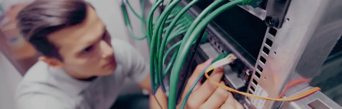 Electrician from Ideal Electrical working on a data cabling installation.