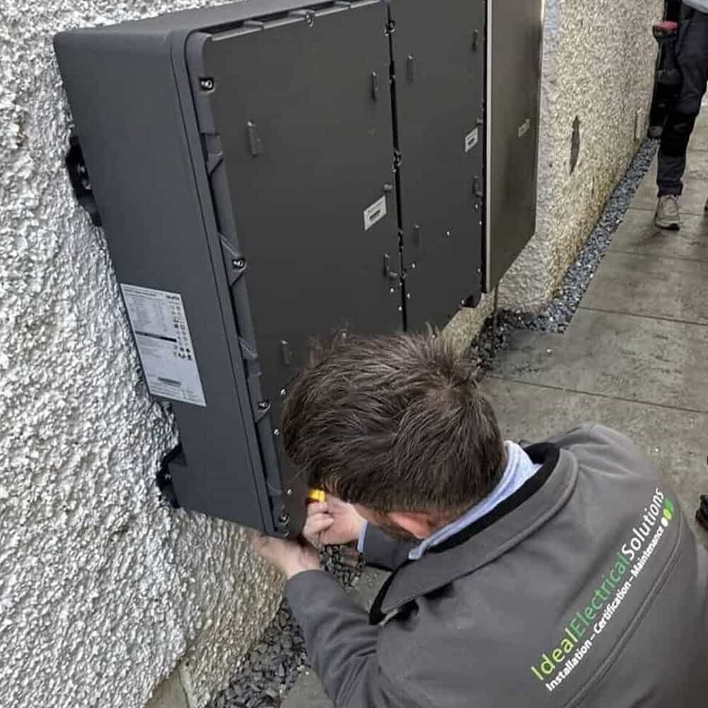 Home solar battery storage system being repaired and serviced.