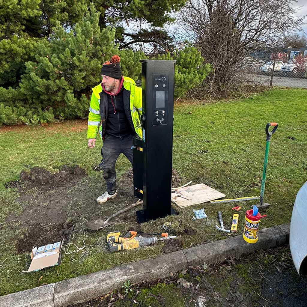 Ideal electrician terminating cables at the pedestal EV charger.
